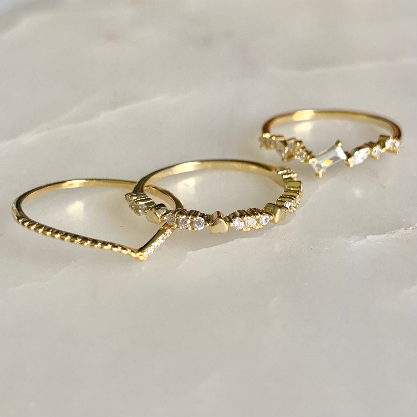 Kay is a lovable ring with the heart shaped pebbles and petite cubic zirconia crystals along halfway on a 14k gold plated band. Kay is so perfect for stacking or wearing it alone for a clean and simple look.