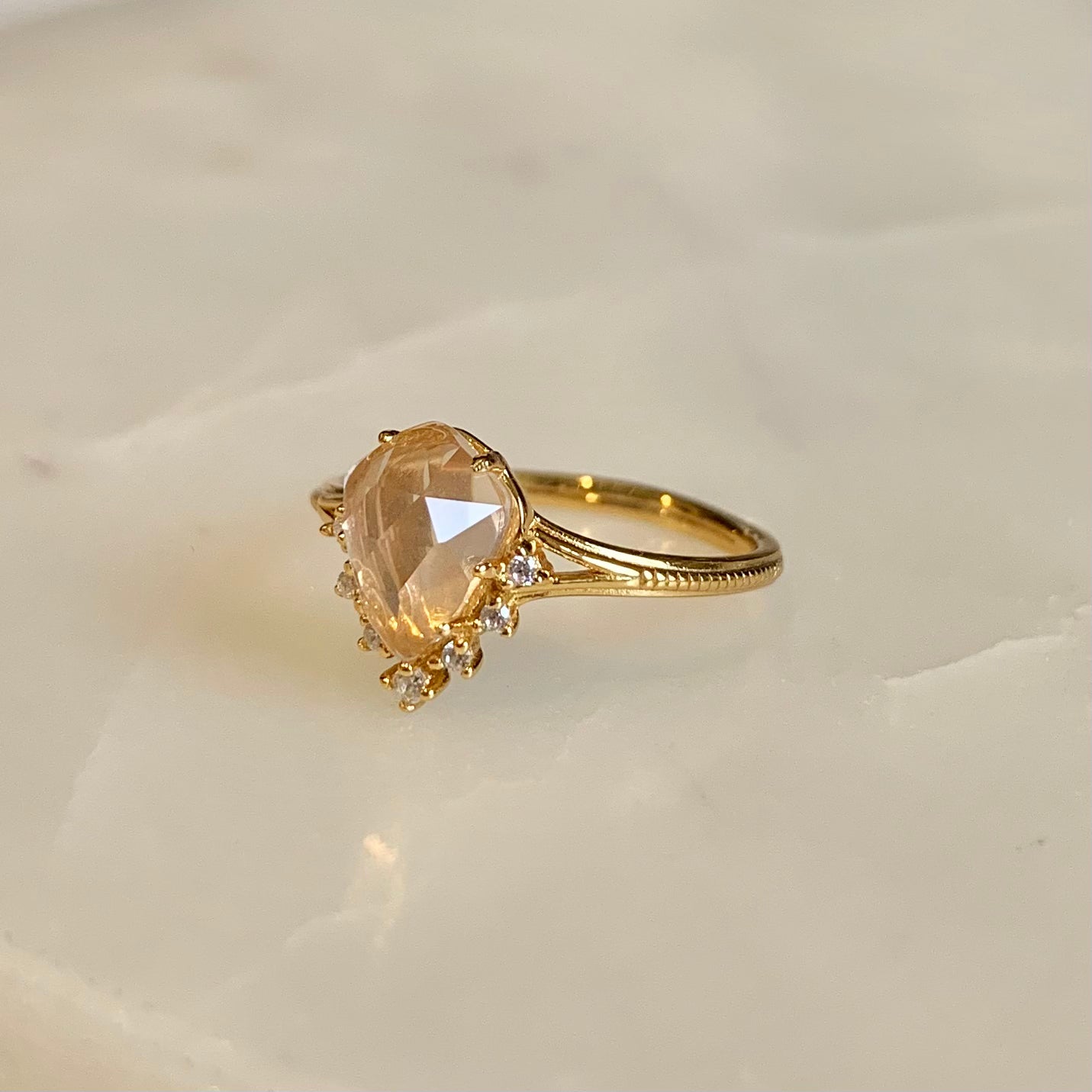 This Victoria Rose Quartz Ring features a unique fairy-tale design, crafted with a teardrop natural rose quartz and accented with cubic zirconia crystals along its tip. Its delicate feminine aesthetics make it the perfect accessory to complete any outfit.