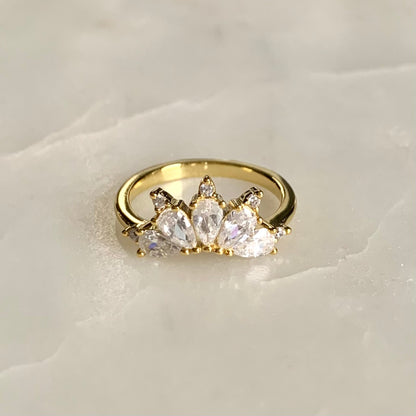 The Magic Ring is an ultimate crown ring in 14K yellow gold Vermeil. It is embellished with five sparkling cubic zirconia crystals on a glistening band. The ring gives you an elegant look and is perfect for everyday wear.