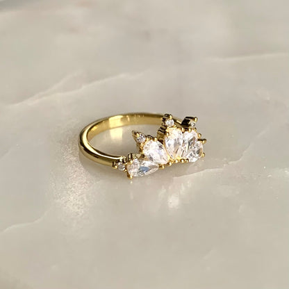 The Magic Ring is an ultimate crown ring in 14K yellow gold Vermeil. It is embellished with five sparkling cubic zirconia crystals on a glistening band. The ring gives you an elegant look and is perfect for everyday wear.