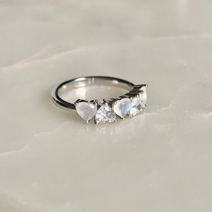 Mila is a stunning five-stone ring with a glistening band. The three heart shaped moonstones and two sparkling cubic zirconia crystals are held in a prong setting and arranged in an alternating pattern.