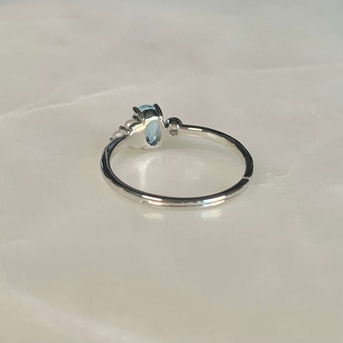 The Azora Sky Blue Topaz Ring has a natural sky blue topaz set in the centre, embellished with three freshwater pearls and a cubic zirconia crystal on the sides.  Blue topaz symbolises honesty, clarity of feelings, and deep emotional attachment. This is perfect as a friendship ring.