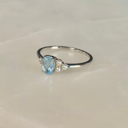 The Azora Sky Blue Topaz Ring has a natural sky blue topaz set in the centre, embellished with three freshwater pearls and a cubic zirconia crystal on the sides.  Blue topaz symbolises honesty, clarity of feelings, and deep emotional attachment. This is perfect as a friendship ring.