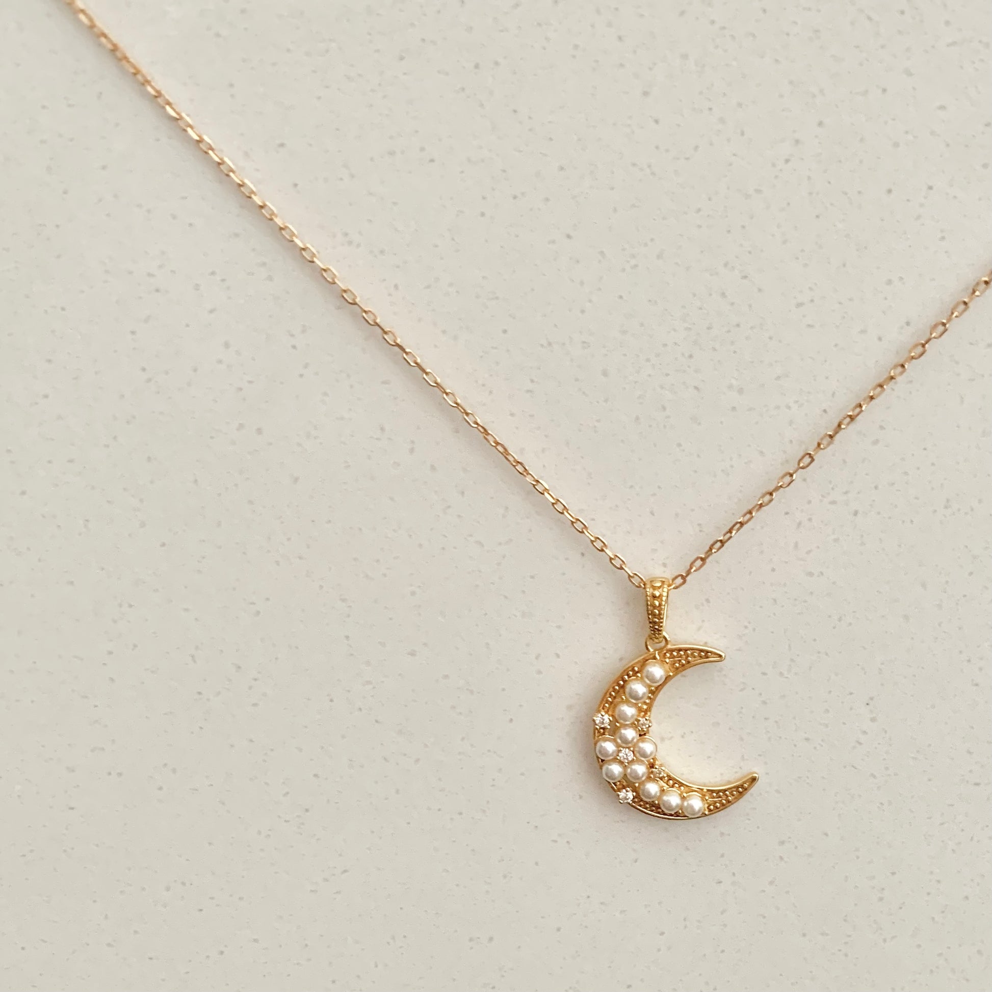 This exquisite Crescent Pearls Necklace is a must-have for moon lovers! It's handcrafted with freshwater pearls, featuring an elegant crescent design perfect for accessorising any outfit. Its beautiful and unique design is sure to make a statement, providing a look that's both timeless and modern.