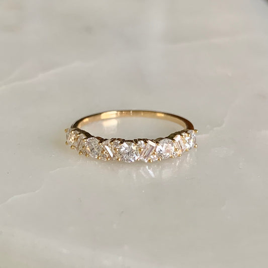 Our Jocelyn ring has a total of seventeen cubic zirconia crystals, they are setting alternately along halfway on a 18k gold plated band. Joycelyn is a beautiful statement ring to wear on its own. It also goes so well with our other stacking rings.