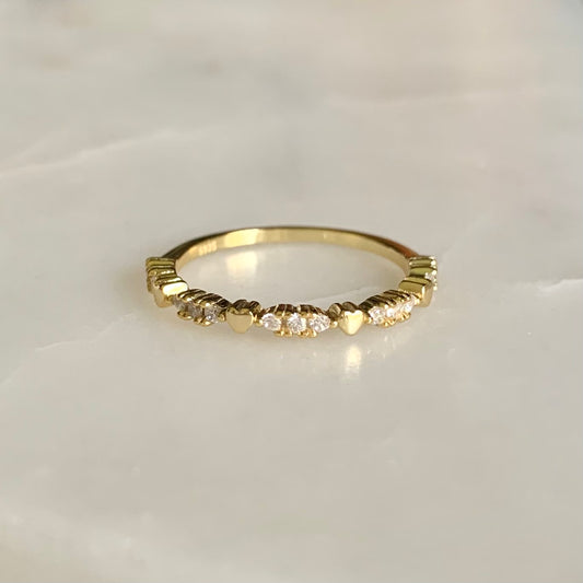 Kay is a lovable ring with the heart shaped pebbles and petite cubic zirconia crystals along halfway on a 14k gold plated band. Kay is so perfect for stacking or wearing it alone for a clean and simple look.