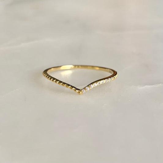 Julianna is a V-shaped stacking ring. If you look at it closer, there is a row of cubic zirconia crystals sit on one side of the band. This dainty and delicate style is so well on pairing with any statement and stacking rings. 