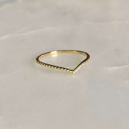 Julianna is a V-shaped stacking ring. If you look at it closer, there is a row of cubic zirconia crystals sit on one side of the band. This dainty and delicate style is so well on pairing with any statement and stacking rings. 