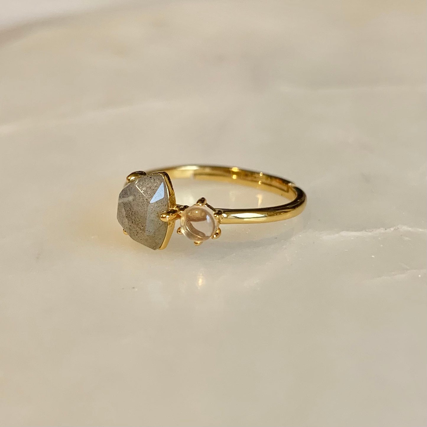 The Clementine Labradorite Ring has a natural labradorite and rose quartz set on the gold band. Labradorite and Rose Quartz is the perfect combination of self-protection and self-love. They accomplished each other by encouraging you to explore your magical and powerful self, while calming your mind and against negative.