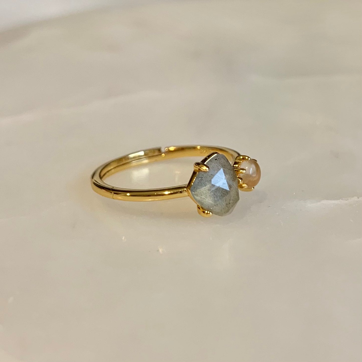 The Clementine Labradorite Ring has a natural labradorite and rose quartz set on the gold band. Labradorite and Rose Quartz is the perfect combination of self-protection and self-love. They accomplished each other by encouraging you to explore your magical and powerful self, while calming your mind and against negative.