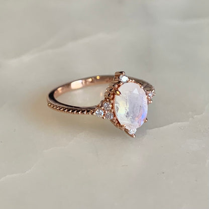 14K rose gold vermeil Queenie Moonstone Ring.  It has an oval moonstone set in a classic four-prong setting, embellished with tiny round beads and sparkling cubic zirconia crystals which highlights the femininity of its design. It is a truly meaningful piece of wearable art. 